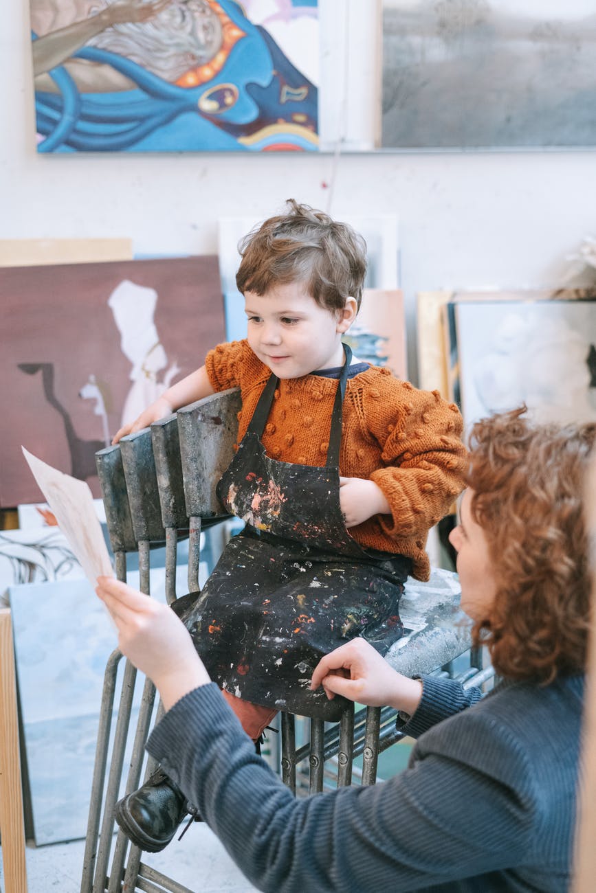 a boy looking at his artwork